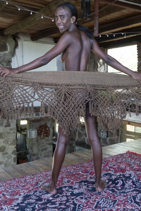 Skinny ebony babe Luz M flaunts her small breasts during a sexy striptease